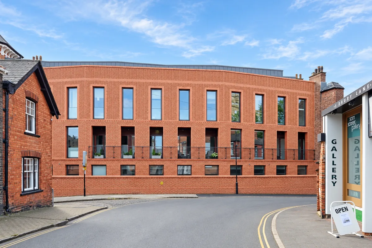 Bailgate Court terrace curving along the street between two older brick buildings