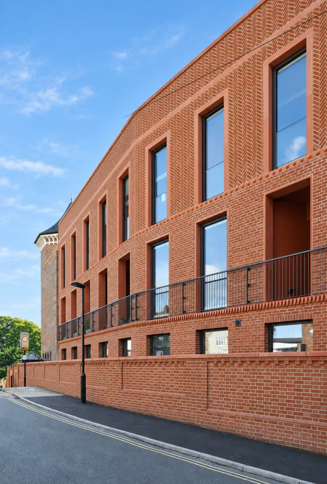 Bailgate Court &mdash; herringbone brickwork and deep window reveals on the new terrace